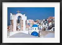 Framed Bell tower and blue domes of church in village of Oia, Santorini, Greece