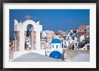 Framed Bell tower and blue domes of church in village of Oia, Santorini, Greece