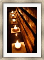 Framed Lighted Candles and Brick Wall