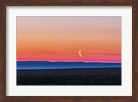 Framed Moon and Venus rising over the flat prairie horizon of Alberta, Canada