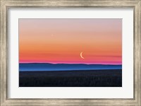 Framed Moon and Venus rising over the flat prairie horizon of Alberta, Canada