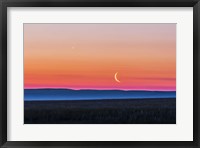 Framed Moon and Venus rising over the flat prairie horizon of Alberta, Canada