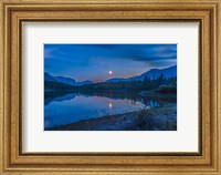 Framed Crescent moon over Middle Lake in Bow Valley, Alberta, Canada