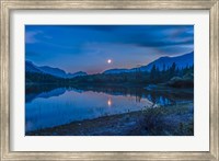 Framed Crescent moon over Middle Lake in Bow Valley, Alberta, Canada