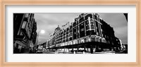 Framed Low angle view of buildings lit up at night, Harrods, London, England BW