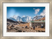 Framed Trekkers and yaks in Lobuche on a trail to Mt Everest