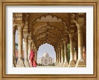 Framed Woman in traditional Sari walking towards Taj Mahal