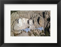 Framed Two F/A-18E Super Hornets conduct a fly by of Mount Rushmore