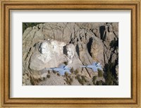 Framed Two F/A-18E Super Hornets conduct a fly by of Mount Rushmore