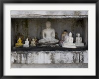 Framed Niche at Ruwanwelisaya Dagoba filled with Buddha statues as offerings, Anuradhapura, Sri Lanka