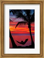 Framed Woman in hammock, and palm trees at sunset, Fiji