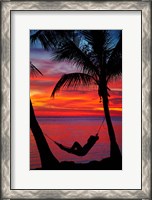 Framed Woman in hammock, and palm trees at sunset, Fiji