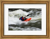 Framed Kayaker plays in a hole in Tariffville Gorge, Farmington River in Tariffville, Connecticut