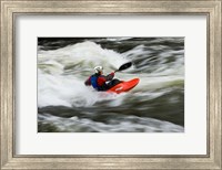 Framed Kayaker plays in a hole in Tariffville Gorge, Farmington River in Tariffville, Connecticut