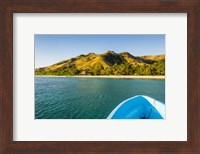 Framed Blue boat cruising through the Yasawa, Fiji, South Pacific