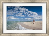 Framed Woman walking on white sand beach of Beachcomber Island, Mamanucas Islands, Fiji
