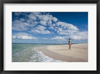 Framed Woman walking on white sand beach of Beachcomber Island, Mamanucas Islands, Fiji