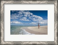 Framed Woman walking on white sand beach of Beachcomber Island, Mamanucas Islands, Fiji