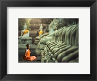 Framed Young Buddhist Monk praying, Thailand