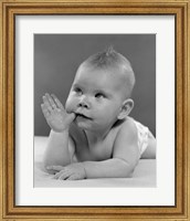Framed 1950s Baby Lying On Stomach With Thumb In Mouth