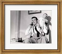 Framed 1950s Father Holding Baby While On The Phone