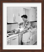 Framed 1950s Housewife In Kitchen Mixing Ingredients
