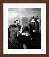 Framed 1920s  Woman With Pen To Lips Wearing Cloche Hat