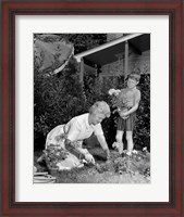 Framed 1960s Boy Helping Grandmother Plant Flowers