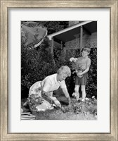 Framed 1960s Boy Helping Grandmother Plant Flowers