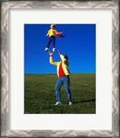 Framed 1990S Father Tossing Daughter Up In The Air